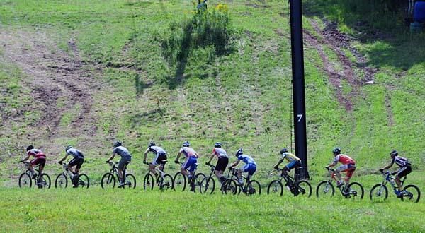 Elite men criss-cross the ski slope on their way up the mountain.