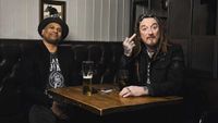 CJ Wildheart and Ginger Wildheart sitting in a pub