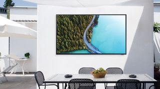Samsung Terrace outdoor TV mounted on white wall outdoors