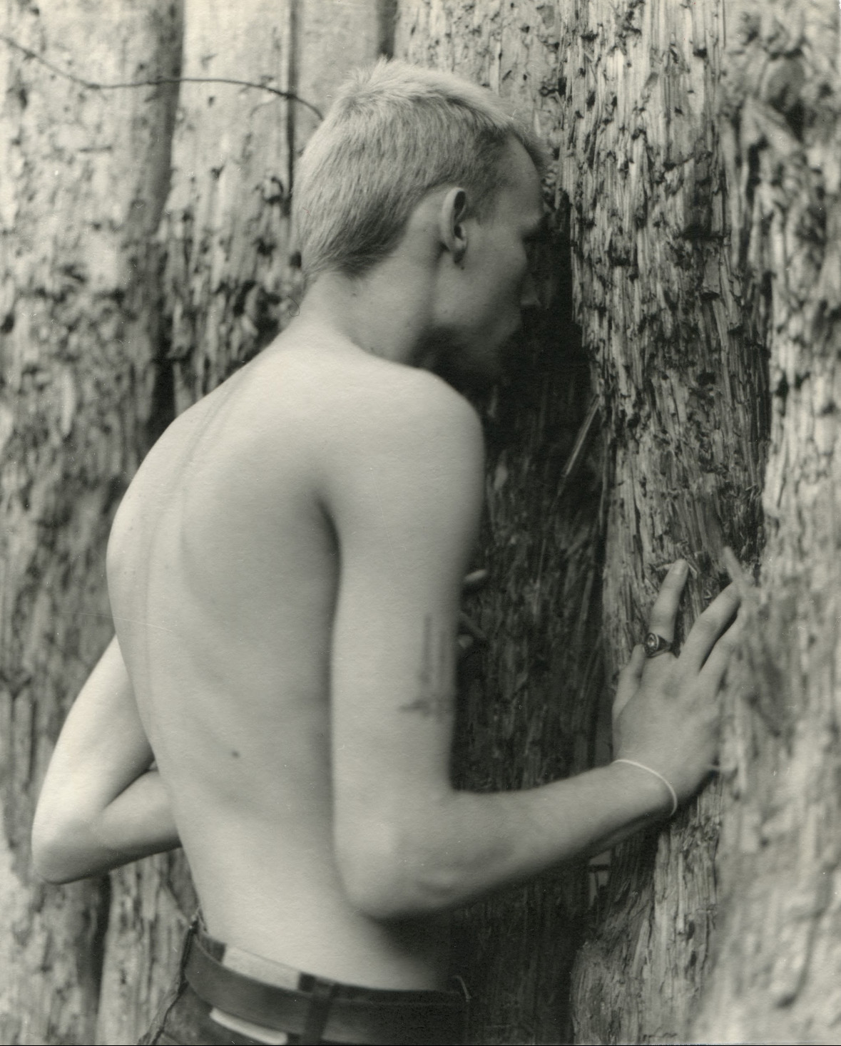 Photo of boy resting against a tree by Vic Bakin