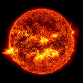 The sun's activity includes solar flares and prominences, both on display in this image.