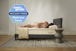 A woman lays on top of the Birch Luxe Natural mattress
