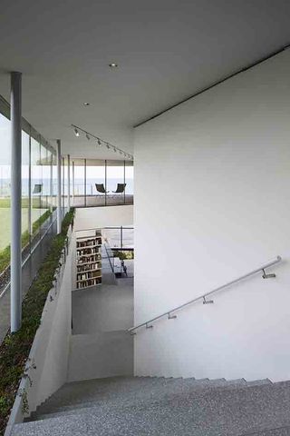 The minimalist main staircase links all floors