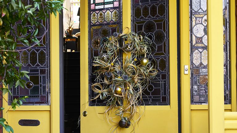Bright and cheery front door color ideas a yellow door with christmas wreath