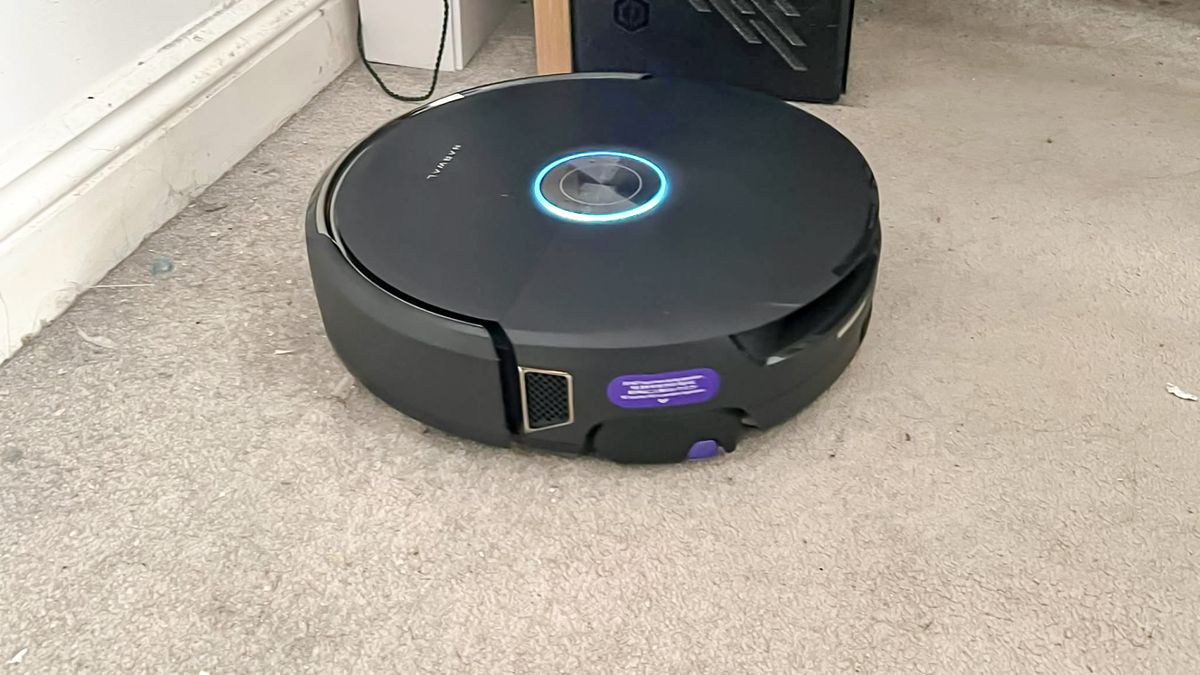 Black Narwhal Flow robot vacuum on a carpet