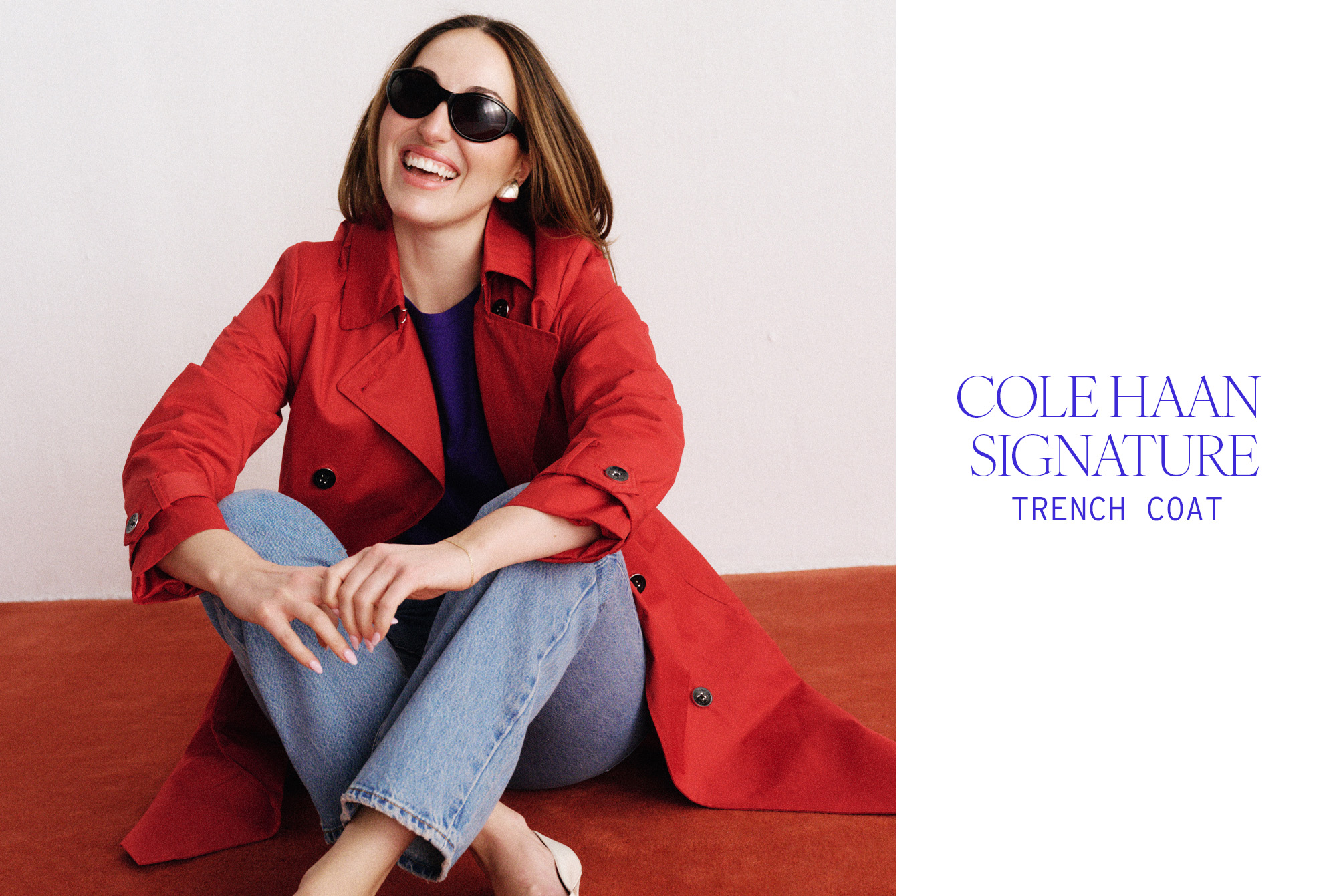 Anna wears a red trench coat and jeans.