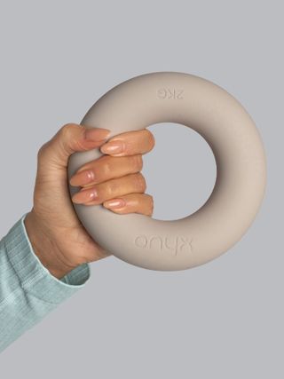 A hand holding a ring weight