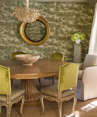 dining room with green toile wallcovering and ime green velvet chairs