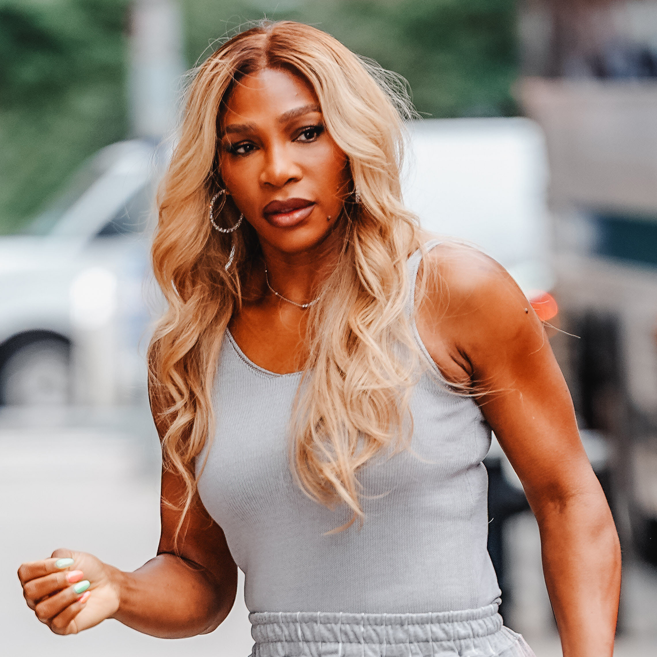 Serena Williams wearing a gray tank top, gray striped pants, and silver pointed-toe heels in NYC 