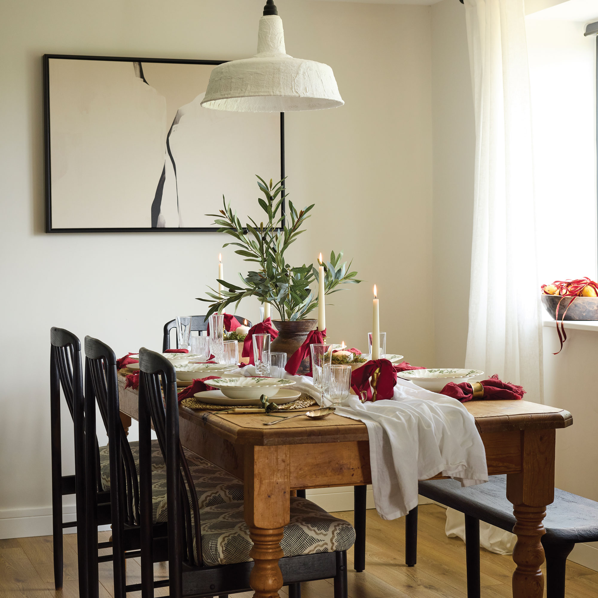 Dining table decorated with red bows for Christmas