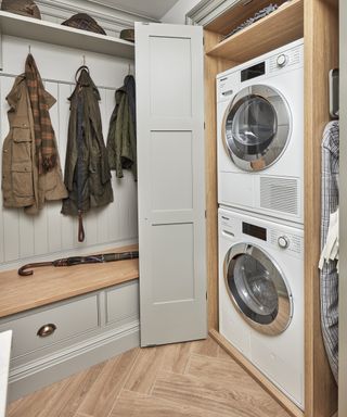 A laundry room with stacked washing machine and dryer