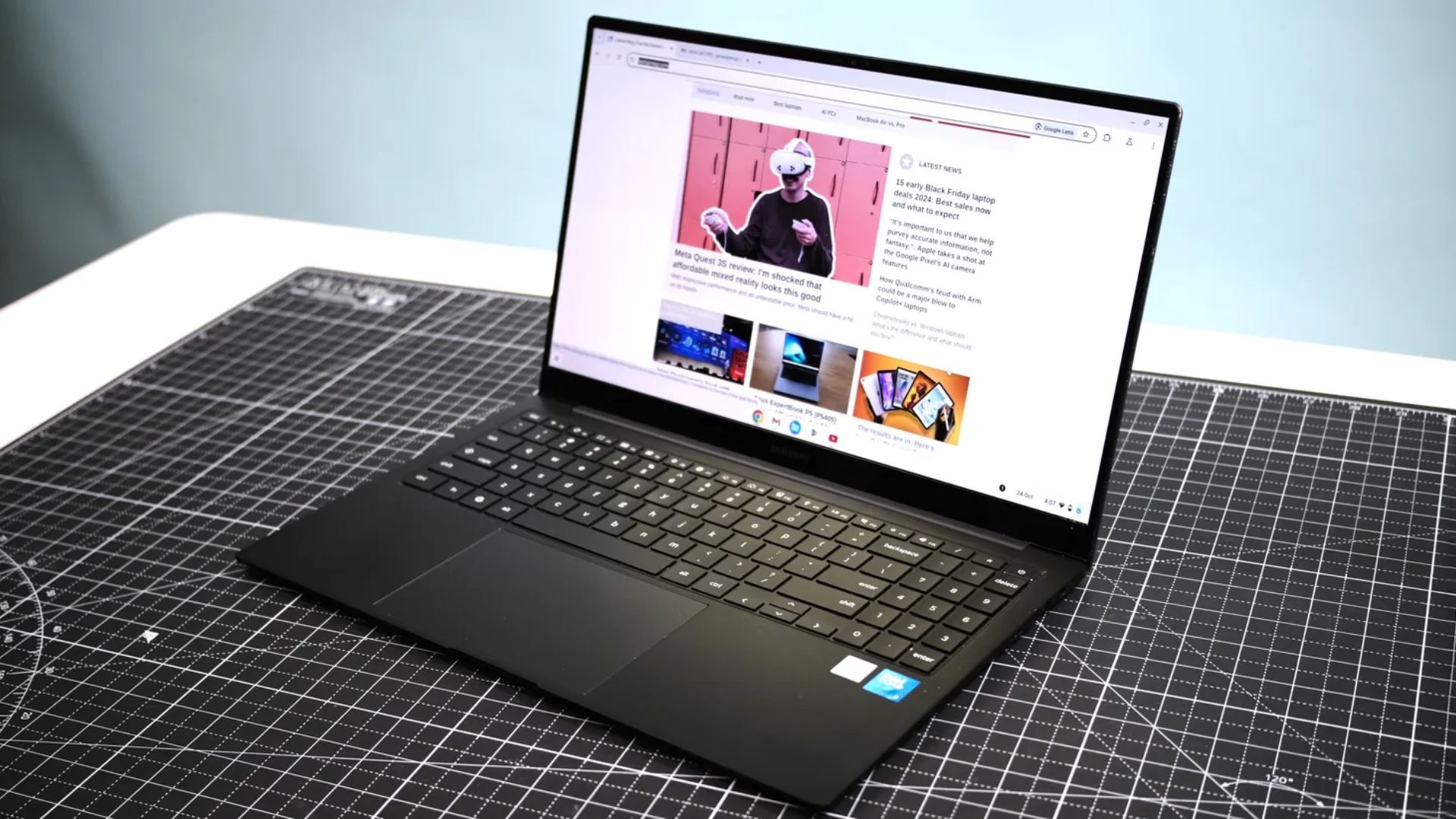 open and powered on samsung galaxy chromebook plus laptop, with the laptopmag home screen showing