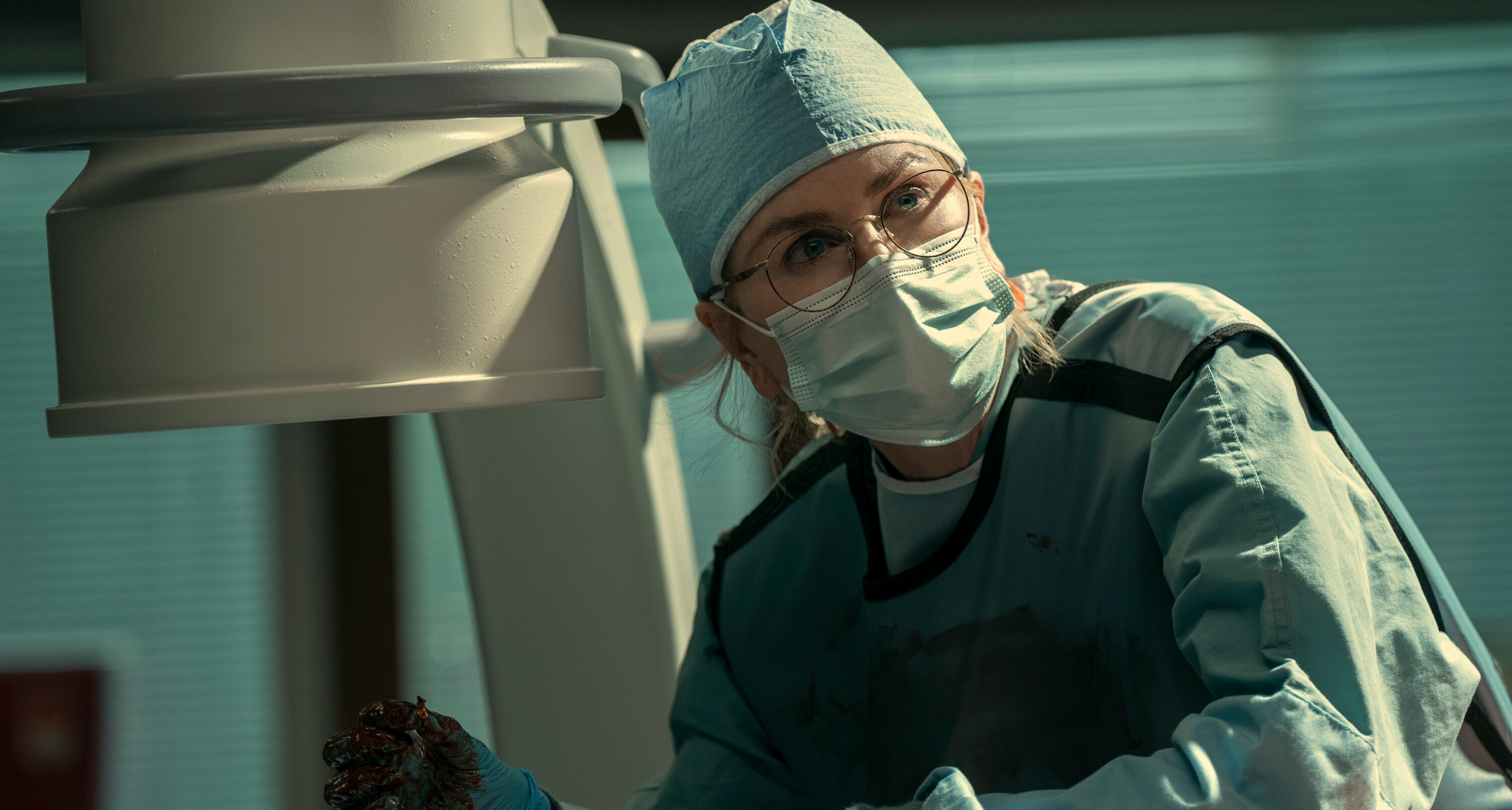 nicole kidman as kay scarpetta in scrubs and a mask doing an autopsy in prime video's scarpetta