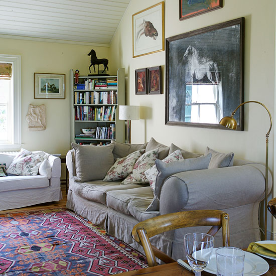 living room with photoframes on white walls and white book shelf