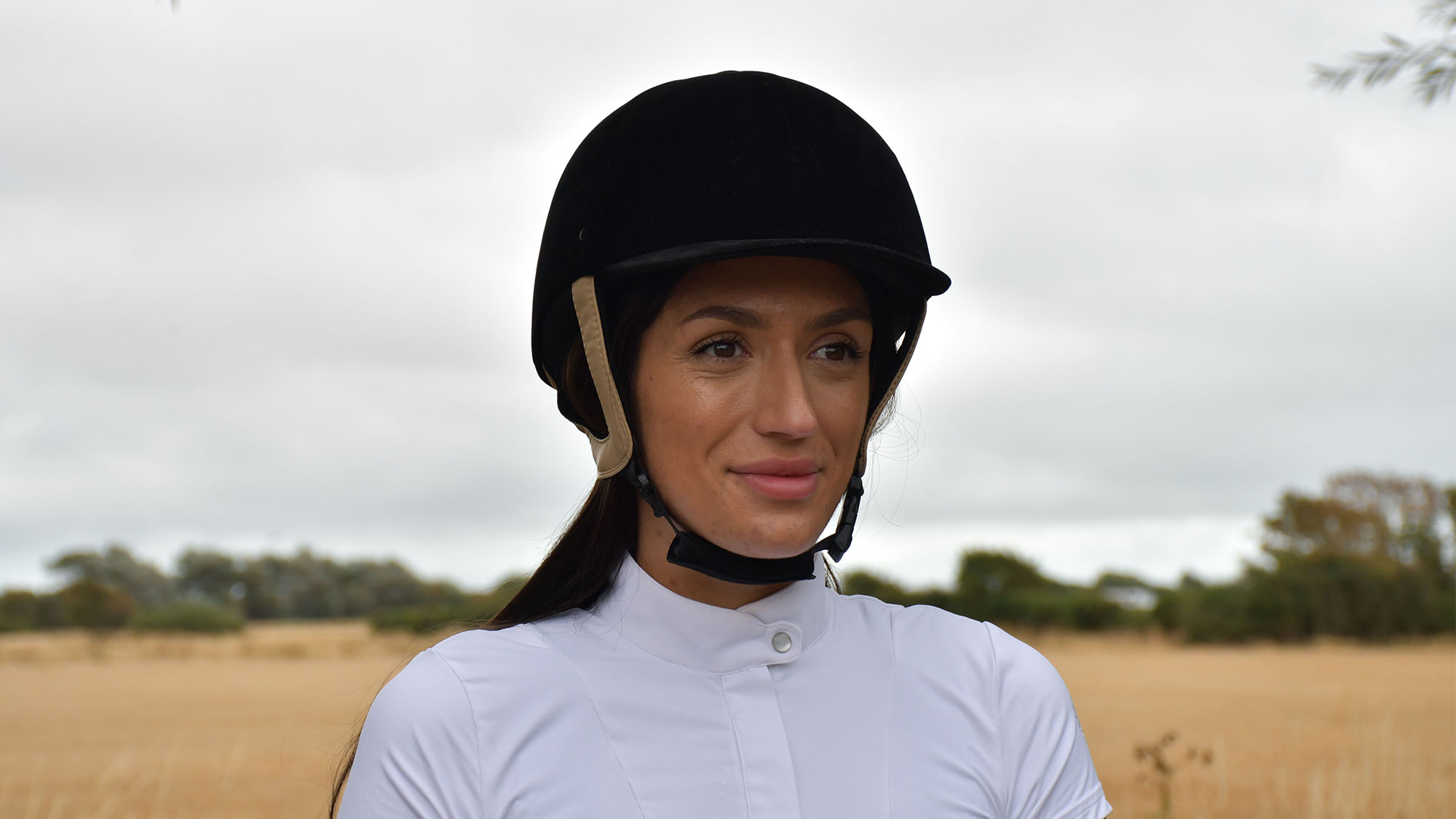Lady wearing a Rhinegold Victory velvet riding hat