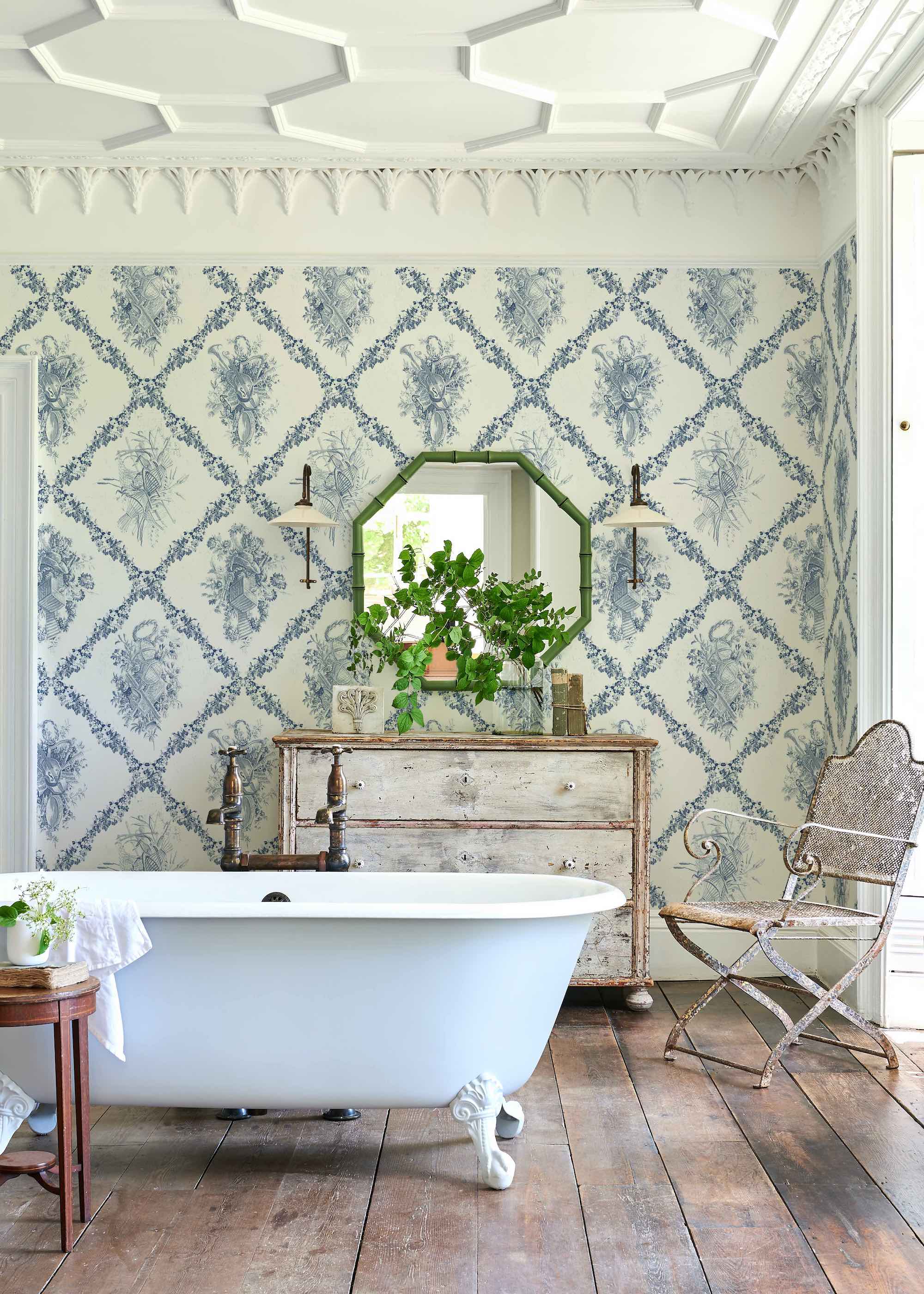 bathroom with patterned wallpaper and roll top bath