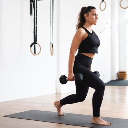 A woman trying dumbbell exercises for beginners at home