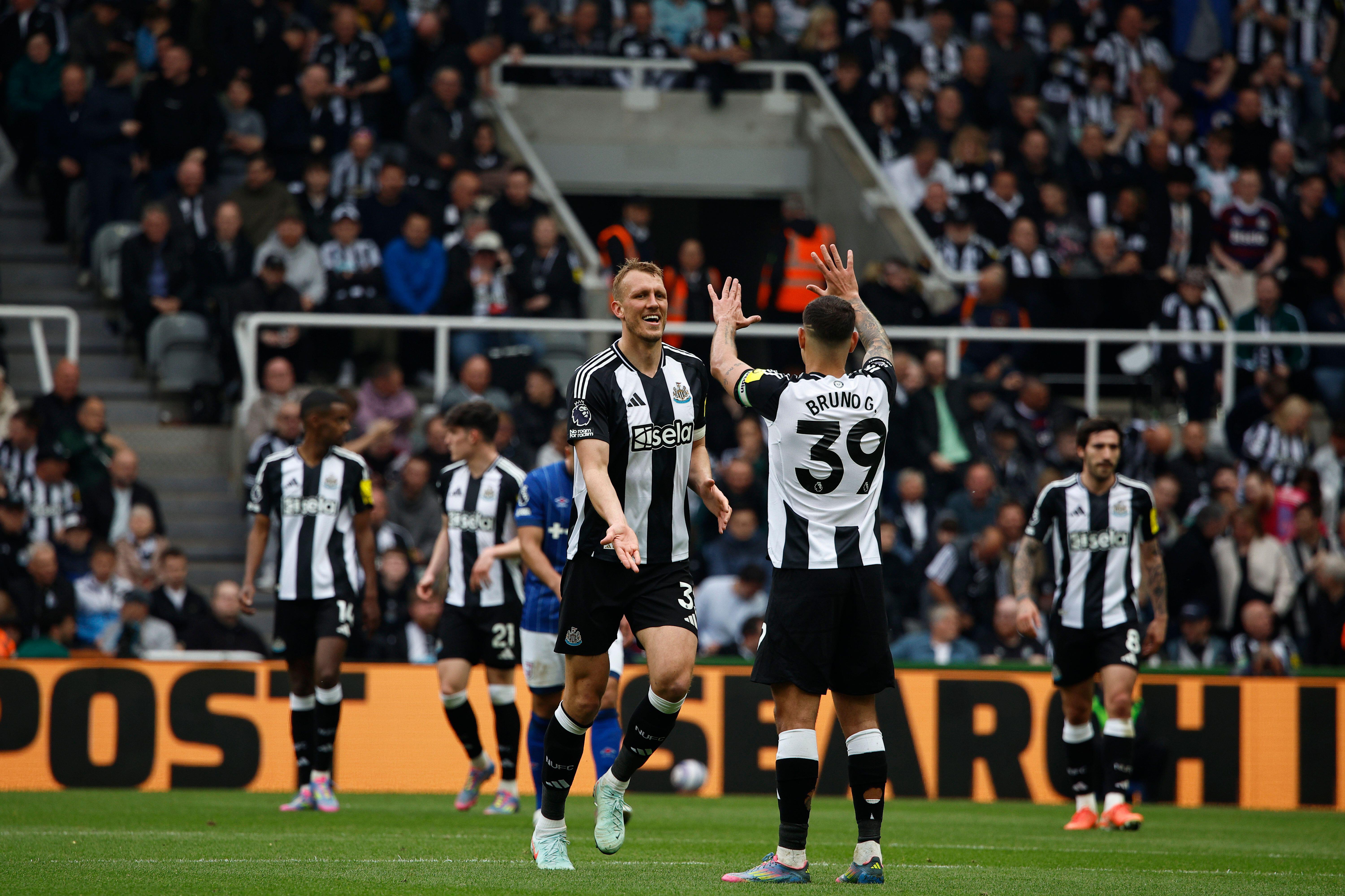 Dan Burn celebrates with Bruno Guimaraes after scoring for Newcastle against Ipswich, April 2025.