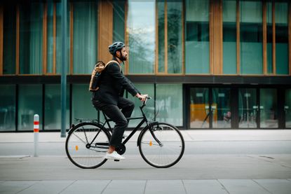 Side view of a city commuter riding to work on a bicycle