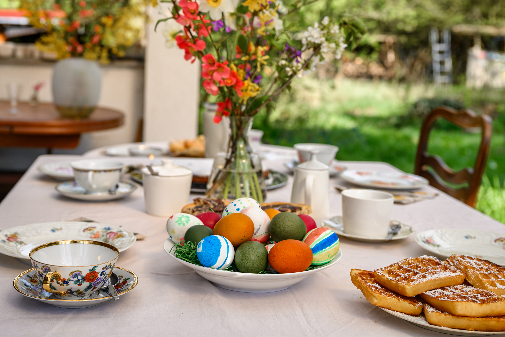 An Easter table spread outside in the garden.