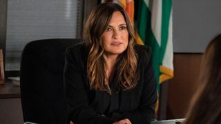 Mariska Hargitay sits at a desk in Law and Order: SVU season 23 on NBC