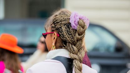 A guest is seen with scrunchies outside Stine Goya during Copenhagen Fashion Week Autumn/Winter 2022 on February 02, 2022 in Copenhagen, Denmark