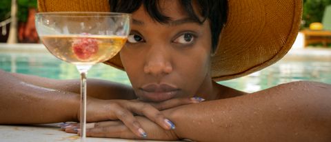 Naomi Ackie with a drink in Blink Twice