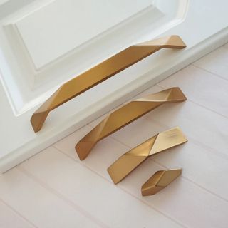 A golden kitchen cabinet handle