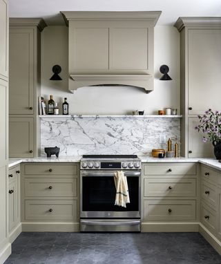 A kitchen with dark flooring and gray cabinets