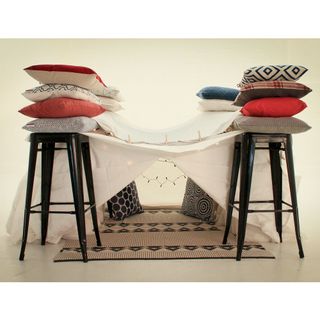 pillow fort with black stool and white flooring