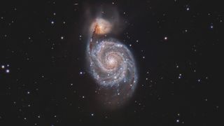 an image of a whirlpool-shaped galaxy in deep space