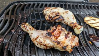 Chicken legs cooking on a grill