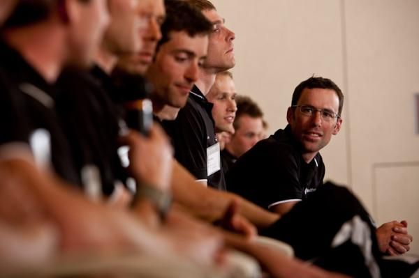 Tim Johnson listens in as teammates speak during the team presentation.