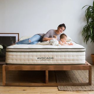 A woman and baby on a mattress