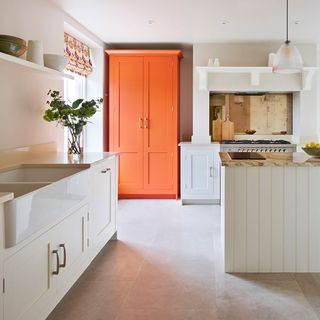 Two tone kitchen cabinet ideas with cream kitchen and orange larder
