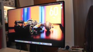 Philips 27B1U7903 4K monitor on a desk, with an F1 car background