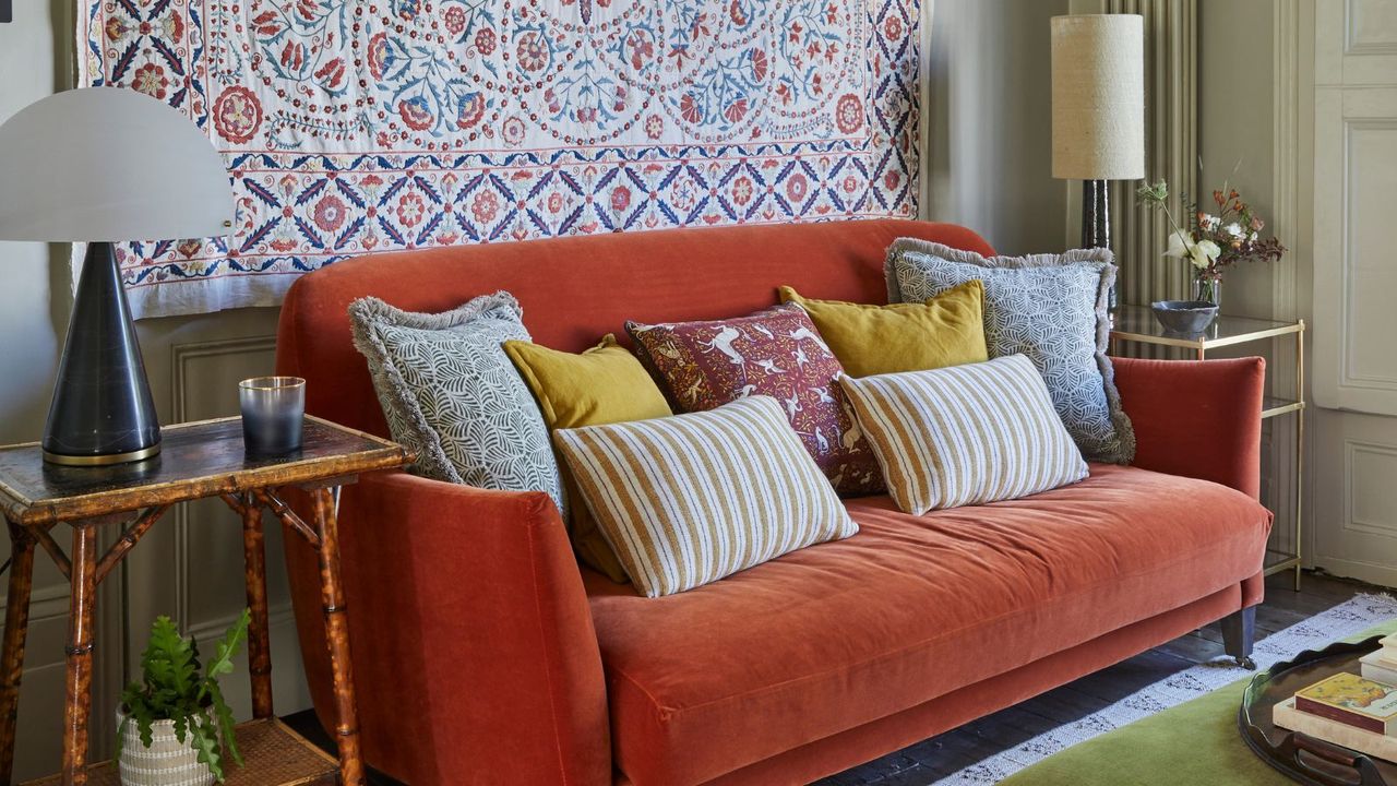 Orange couch with throw pillows