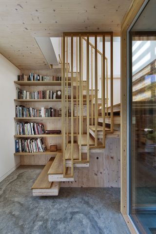 wood clad stairwell with full length bookcase