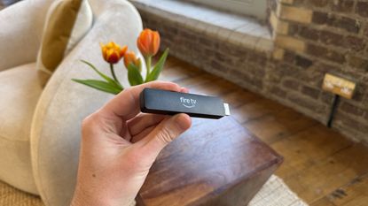 Amazon Fire TV Stick HD being held in a person's hand