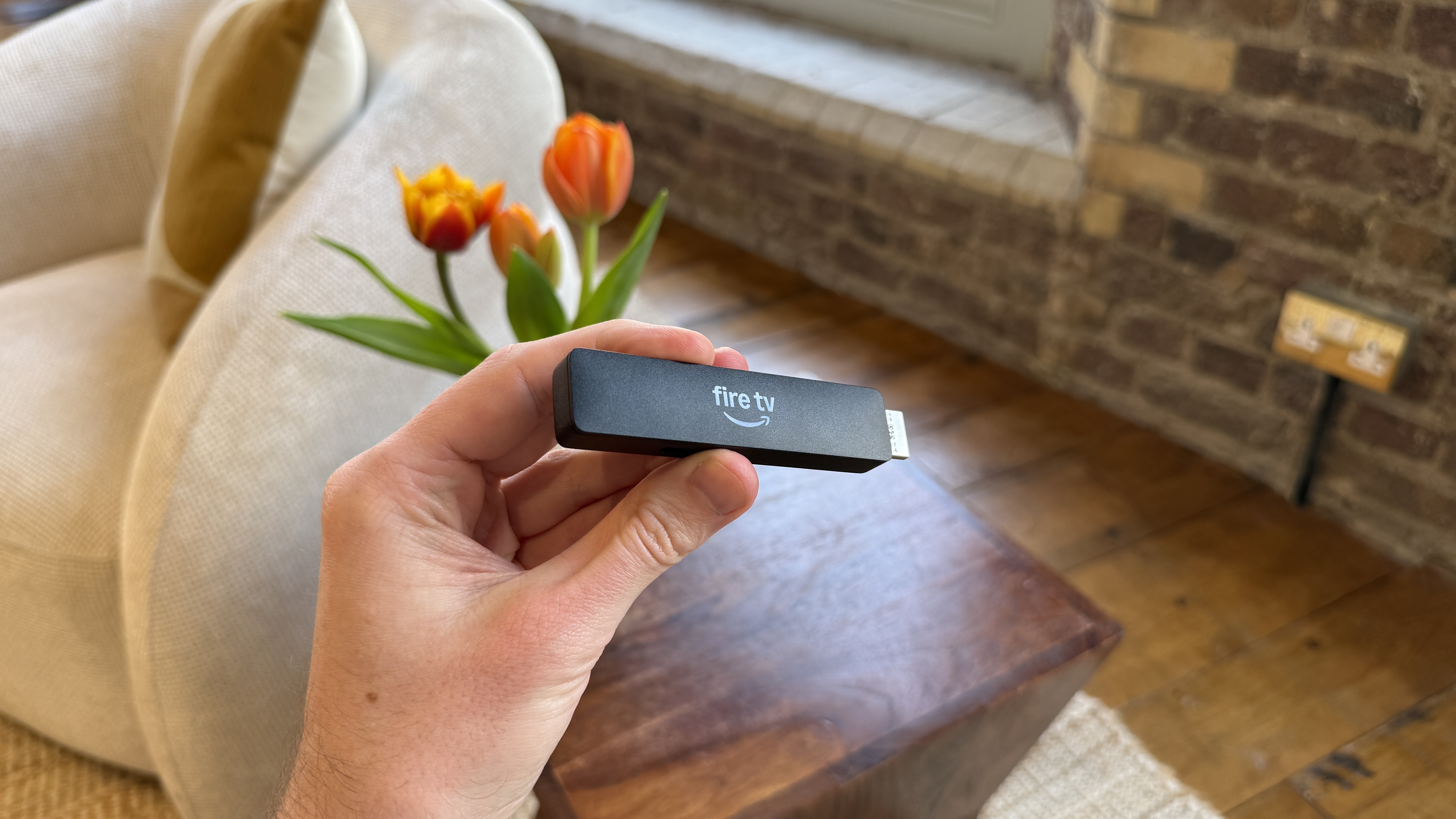 Amazon Fire TV Stick HD being held in a person's hand