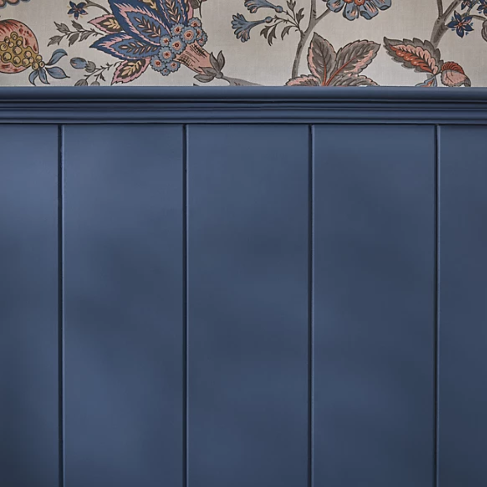 Navy tongue and groove panelling with a patterned wallpaper above it
