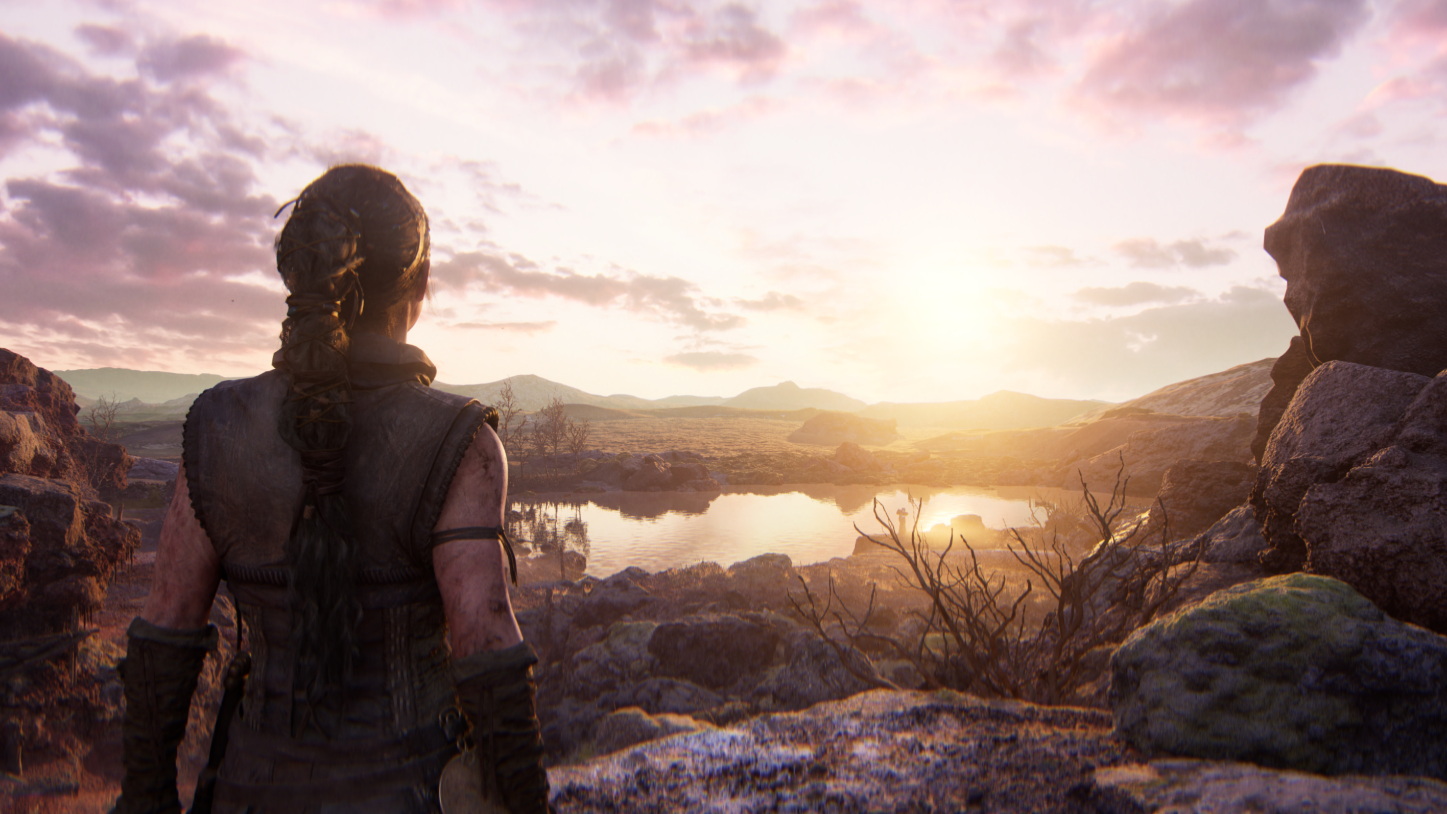 A landscape vista with lake and sunset in Senuas Saga Hellblade 2