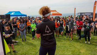 Sabrina Pace Humphreys standing at Black Trail Runners event speaking to an audience