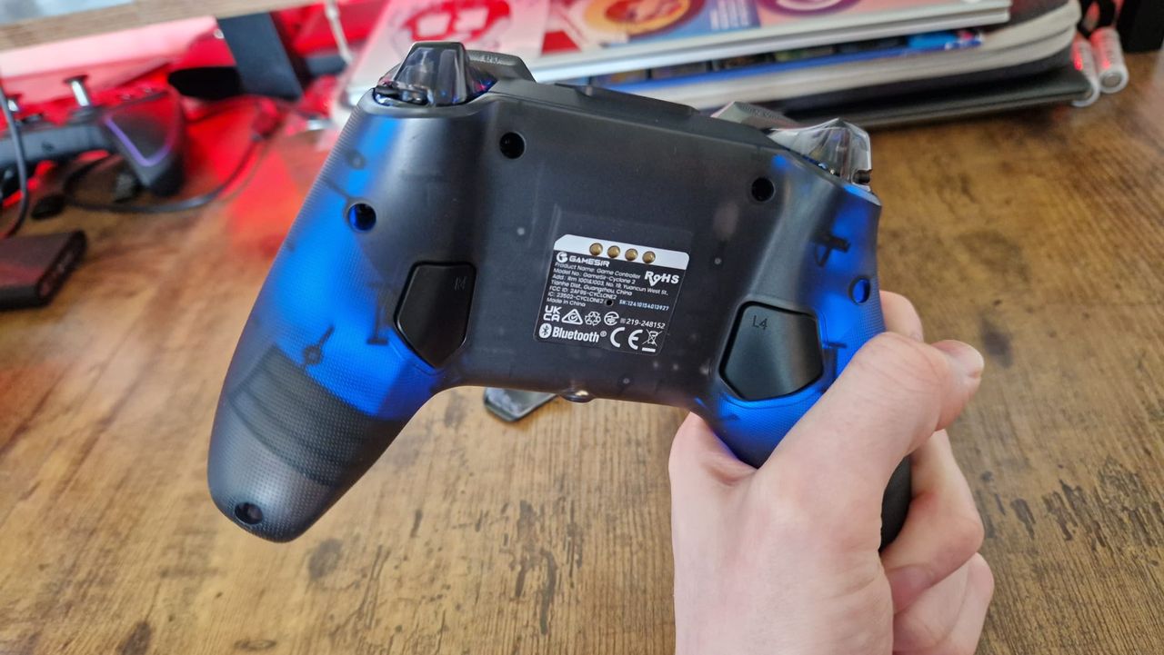 A reviewer showing the back of the GameSir Cyclone 2