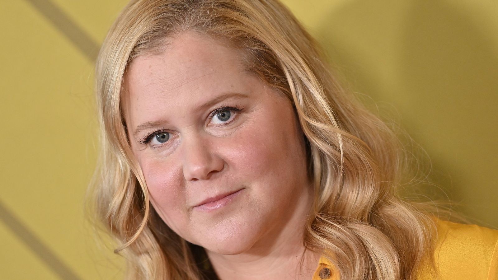 amy schumer on a yellow background