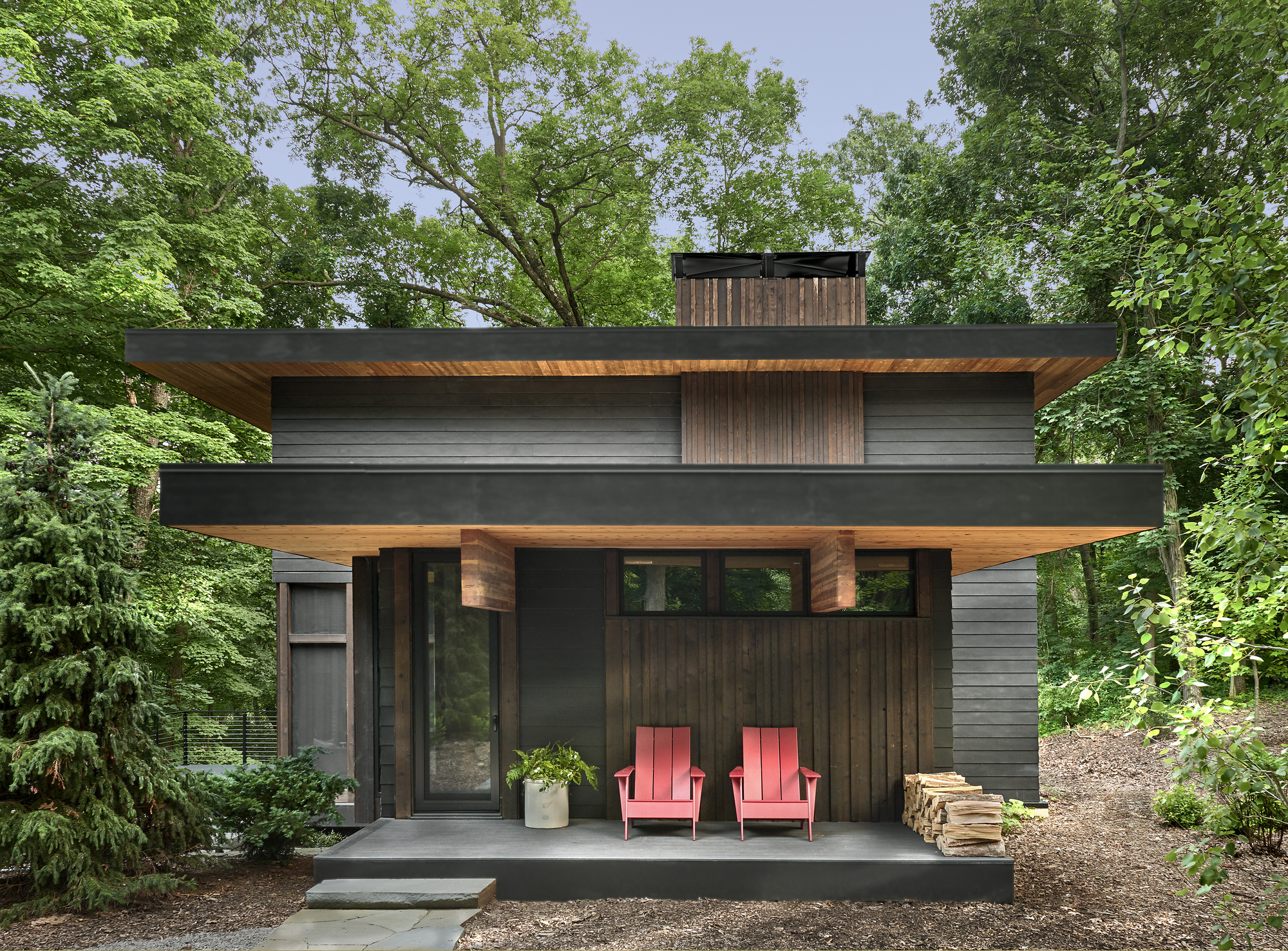 A porch with Adirondack chairs