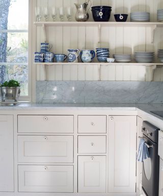 white painted kitchen open shelves and marble countertops