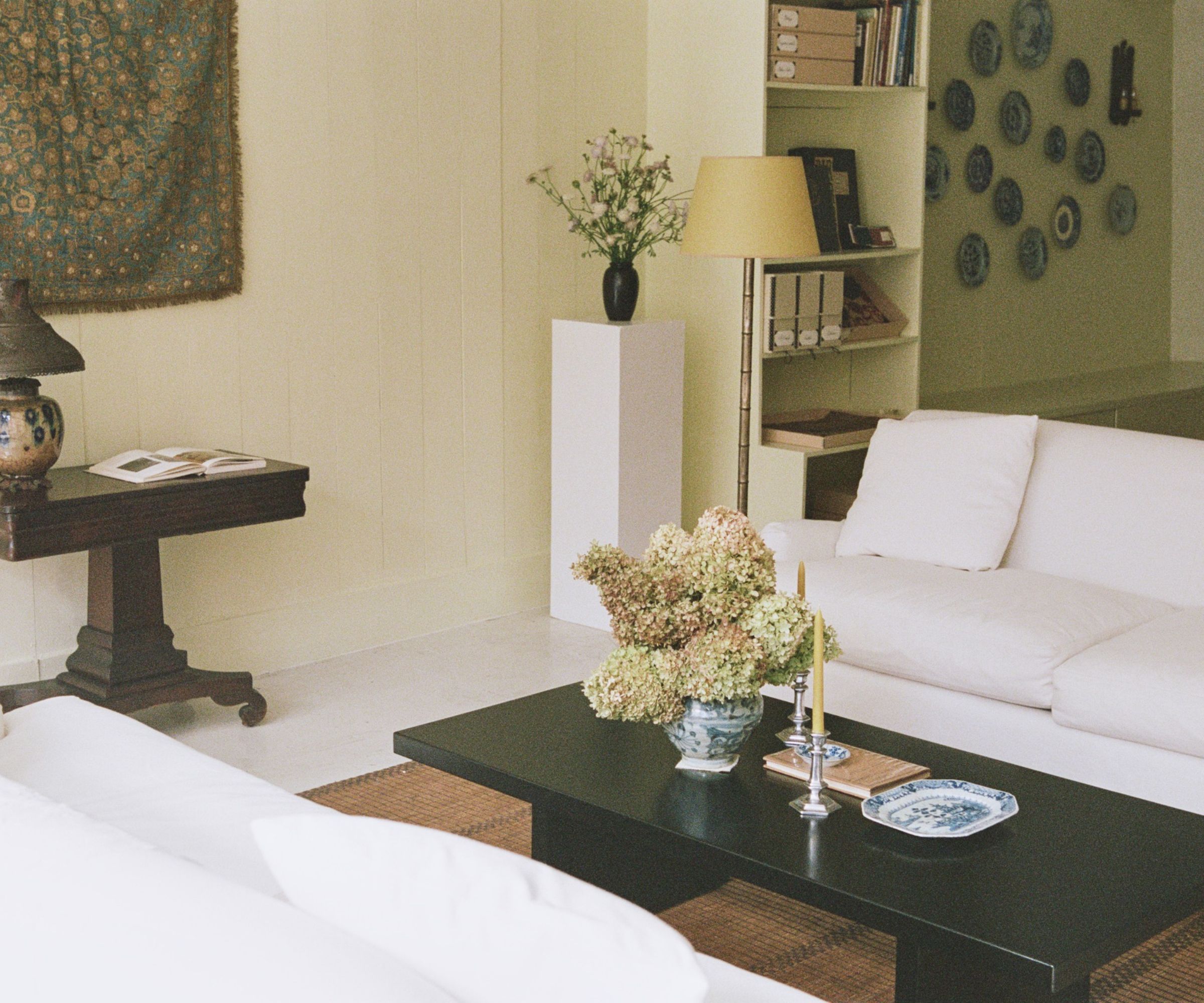 White living room with white sofas facing each other across a black coffee table