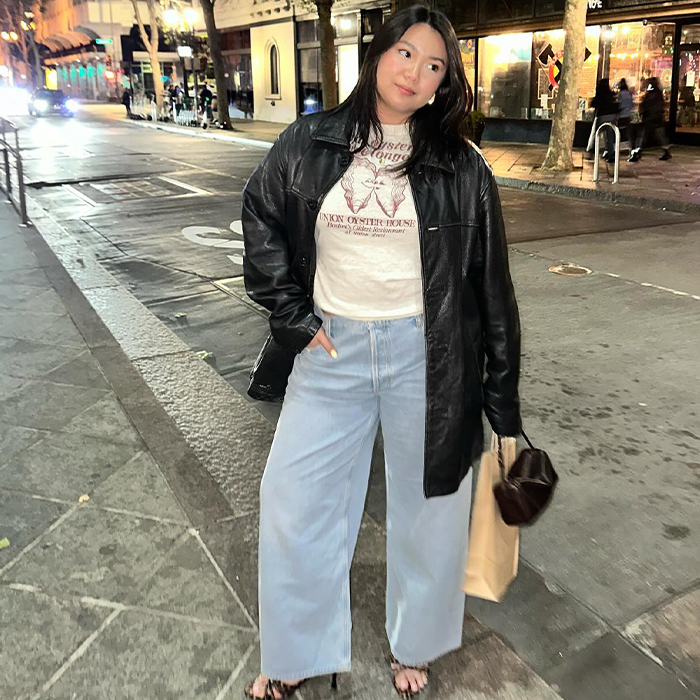 Marina wears white t-shirt, leather jacket, jeans, and a little heel. 