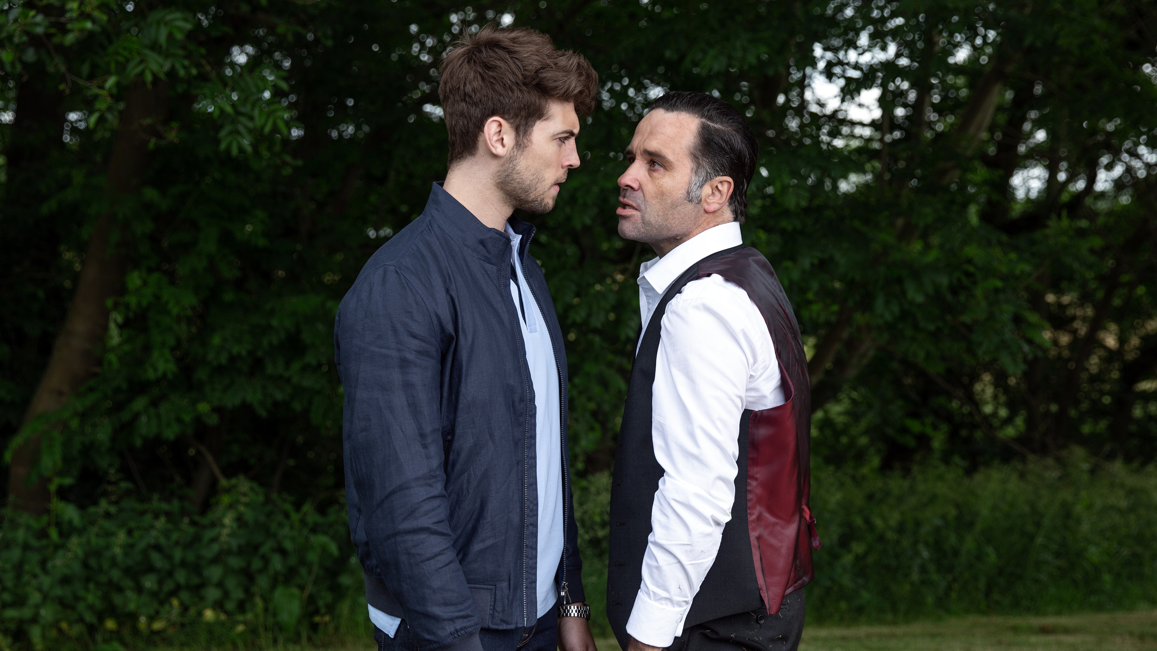 Joe Tate and Graham Foster staring angrily at each other.